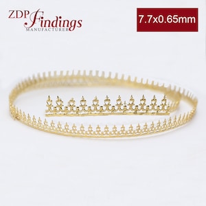 May include: Gold metal trim with a decorative design. The trim is 7.7 x 0.65 mm.
