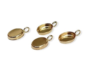 May include: Four gold-toned oval-shaped pendant settings with a loop at the top for attaching to a chain or cord.