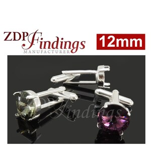 May include: Silver cufflinks with a 12mm round setting for a gemstone. The cufflinks are shown with a dark green and a purple gemstone.