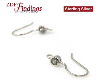 May include: Two sterling silver earring hooks with a small clear crystal at the top of each hook.