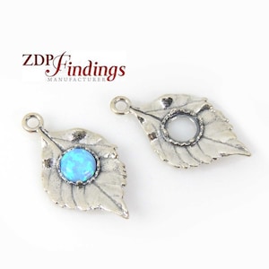 May include: Two silver leaf-shaped charms with a hole at the top for hanging. One charm has a blue opal stone set in the center.  ZDP Findings Manufacturer.