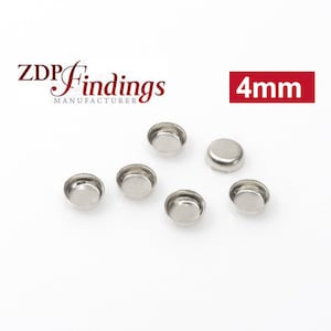 May include: Six silver-colored metal cup-shaped findings, each measuring 4 mm in diameter. The findings are arranged in a semi-circle on a white surface. The text "ZDP Findings Manufacturer" and "4mm" are visible in the image.