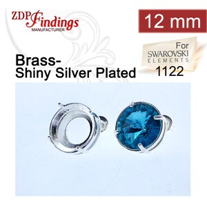 May include: Two shiny silver-plated brass earring settings. One setting is empty, the other holds a round, faceted, teal-coloured crystal. The settings are designed for 12 mm crystals. The text reads "Brass-Shiny Silver Plated".
