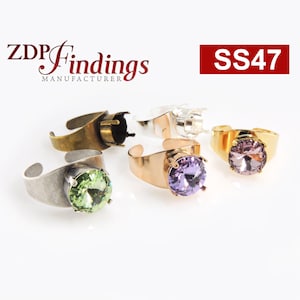 May include: Five ring settings with different coloured stones. The settings are made of silver, gold, and brass. The stones are green, purple, and pink. The rings are labelled SS47.