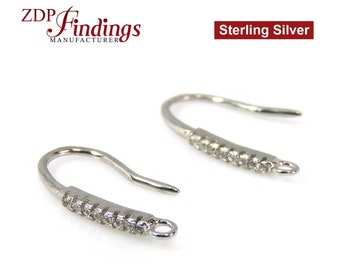 May include: A pair of sterling silver earring hooks with a row of clear cubic zirconia stones.