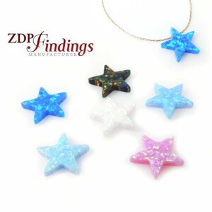 May include: Assortment of six opal star-shaped pendants in various colours, including blue, white, pink, black, and green. The stars are approximately 2.5 cm in size.