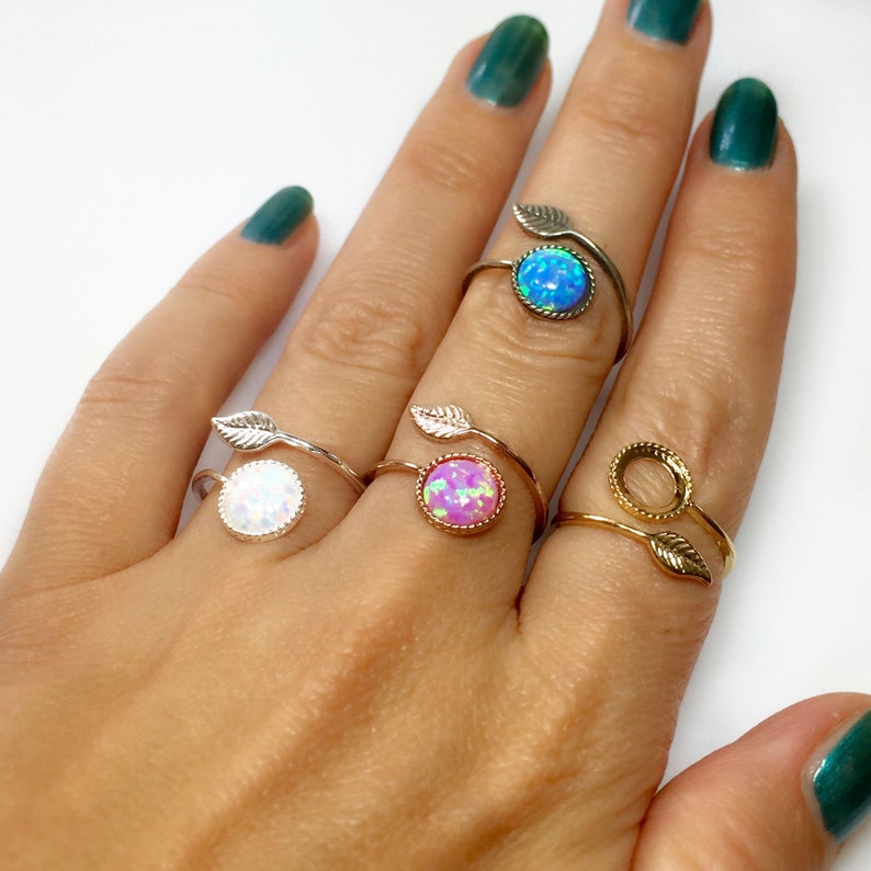 May include: Four adjustable rings with a leaf design and opal stones in white, pink, blue, and clear colors.