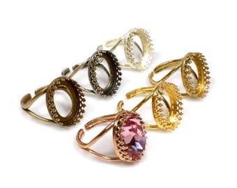 May include: Five oval-shaped ring settings with a decorative border. Four settings are empty and one setting has a pink oval-shaped stone.