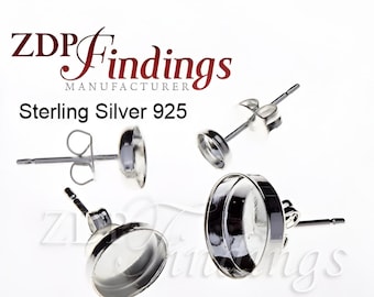 May include: Sterling silver 925 earring settings. The settings are round and have a smooth, polished finish. They are designed to hold a variety of cabochons or other decorative elements.