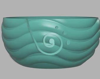 May include: A teal yarn bowl with a wave-like design. The bowl features a decorative swirl and three small circles. The bowl is designed to hold yarn while knitting or crocheting.