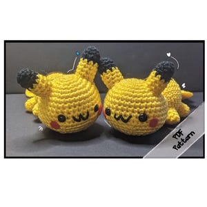 May include: Two yellow crochet Pikachu figures with black-tipped ears and red cheeks. The figures have a smiling face and are lying down. A white ribbon with the text "PDF Pattern" is in the bottom right corner.