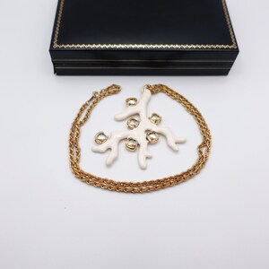 Signed KJL White Coral Pendant Necklace by Kenneth Jay Lane with Enamel on Gold Tone Metal - Statement Piece - by box with necklace wrapped around pendant