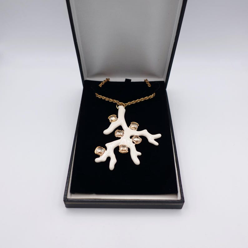 Signed KJL White Coral Pendant Necklace by Kenneth Jay Lane with Enamel on Gold Tone Metal - Statement Piece - overview of pendant in box