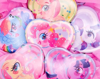 May include: Six heart-shaped pins featuring My Little Pony characters. Each pin has a different character with a colorful background. The pins are arranged in a circle on a pink background.