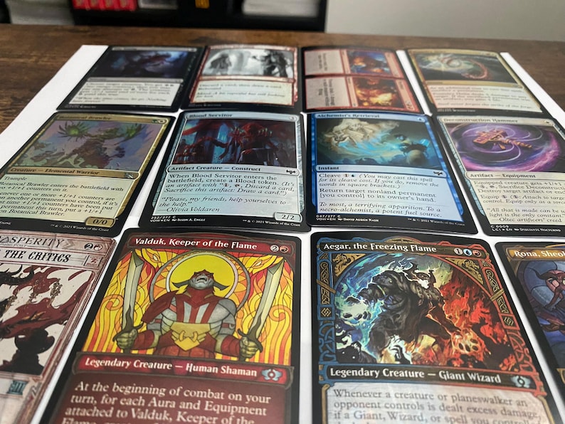 May include: A collection of Magic: The Gathering trading cards, featuring various card designs and artwork. The cards display text and illustrations, with a focus on fantasy themes and creatures. The cards are arranged on a white surface.