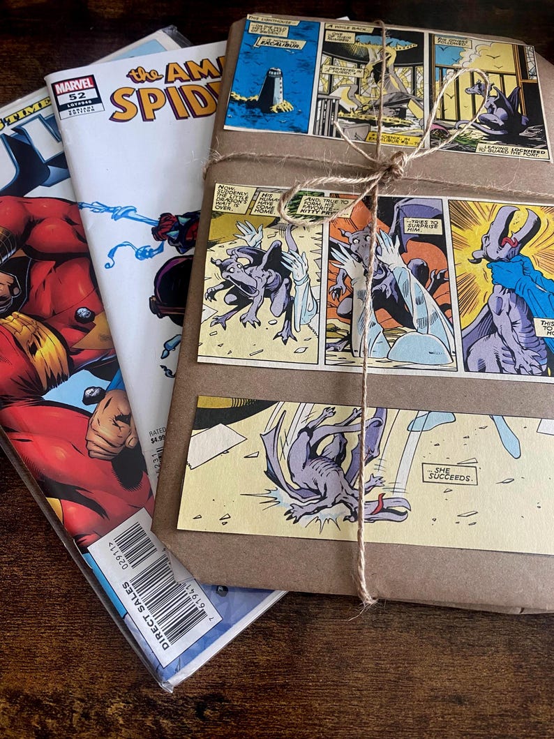 Pu&ograve; includere: Una pila di fumetti tra cui The Amazing Spider-Man numero 52, accanto a un pacchetto rettangolare avvolto in carta marrone. Il pacchetto &egrave; legato con uno spago sottile e decorato con vignette di fumetti raffiguranti una creatura viola.