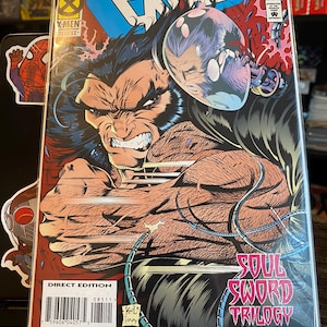 May include: A comic book cover featuring a red, white, and blue color scheme. The cover features a character with a large, sharp claw, and the title "Excalibur" in large, bold letters. The text "Soul Sword Trilogy Part III" is also visible on the cover.