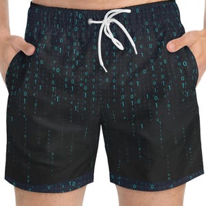 May include: Black swim trunks featuring a digital matrix pattern with cascading teal blue ones and zeros. The shorts have an elastic waistband with a white drawstring cord and two side pockets, displaying a repeating binary code design throughout.
