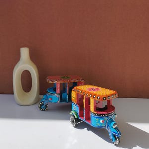 Colorful Indian auto rickshaw wooden toy close-up