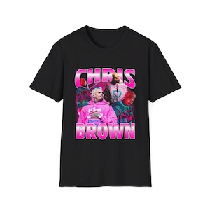 May include: Black t-shirt with a pink graphic of Chris Brown. The graphic features a pink and white image of Chris Brown with the text "CHRIS BROWN" in pink letters.