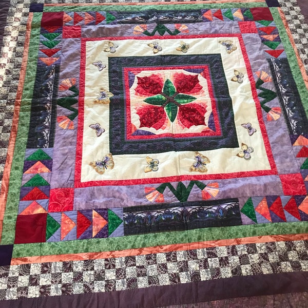 Handcrafted quilt, 84 x 84 inches, pieced throw, butterfly appliques, flying geese pattern, red green purple, floral center, tulip design