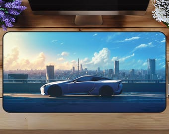 May include: A blue car driving on a city street with a cityscape in the background. The sky is blue with white clouds.