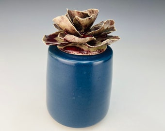 Small keepsake urn in blue with red rose lid