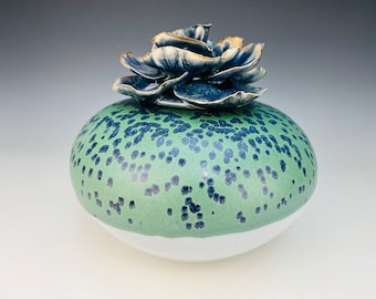 Cremation urn in opal and blue green with flower lid