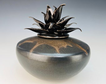 Small keepsake cremation urn with sculpted flower in  black