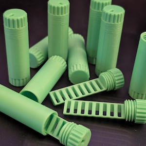 May include: A set of three ceramic mugs with a speckled, matte finish. The mugs are in shades of cream, light gray, and dark gray. Each mug has a simple, minimalist design, perfect for coffee or tea.