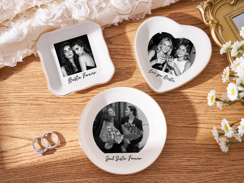 May include: Three white ceramic trinket dishes with gold rims, each featuring a black and white photo. One is square with "Bestie Forever", another heart-shaped with "Love you Bestie", and a round one with "Soul Sister Forever".