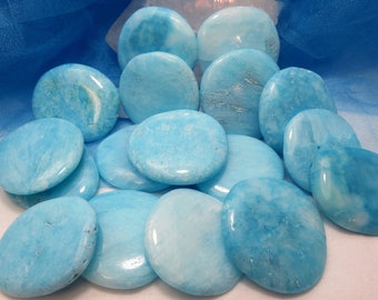 May include: A collection of smooth, polished turquoise blue stones, each with a unique pattern and texture. The stones are arranged in a pile, showcasing their natural beauty.