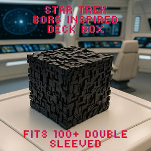 May include: A black, cube-shaped deck box with a textured surface, inspired by Star Trek's Borg. The box is on a white surface, with the text "STAR TREK BORG INSPIRED DECK BOX" and "FITS 100+ DOUBLE SLEEVED" in red. The background suggests a spaceship interior.