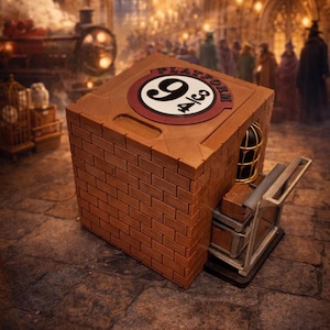 May include: A brown brick-patterned box with a circular sign that reads "Platform 9 3/4". A luggage cart with stacked suitcases is attached to the box. A cage-like window is visible on the side.