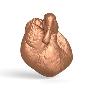 May include: A bronze-colored duck sculpture with detailed feather textures. The duck is depicted in a resting pose, with its head turned slightly to the side. The sculpture is set against a plain white background.