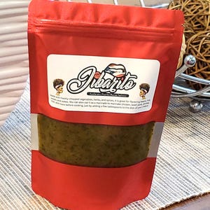 May include: A red pouch of "Jibarito" sofrito, a blend of chopped vegetables, herbs, and spices. The label features the product name and a description of its use as a marinade or flavoring agent for various dishes.