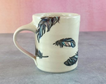 Colorful floating feathers pottery mug // white porcelain mug with feathers, coffee lover's gift, purple blue and pink patterned, bird mug