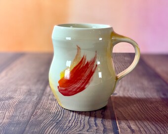 Curvy pottery mug flames // Red and orange glazed mug hand painted swish, unique gift pottery mug creamy white glaze with yellow blush mug