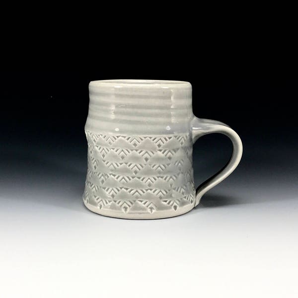 Grey glazed porcelain mug with stamped pattern