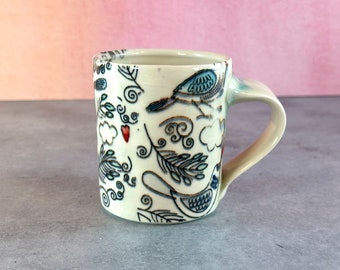 Colorful birds and hearts pottery mug // white porcelain mug with blue birds and feathers, coffee lover's gift, bird mug with red hearts