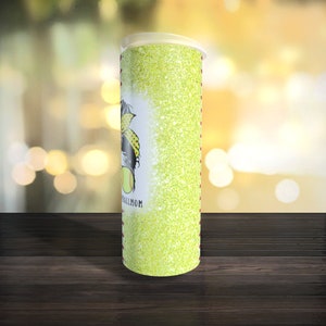 May include: A green glitter tumbler with a softball player graphic and the text "Softball Mom".