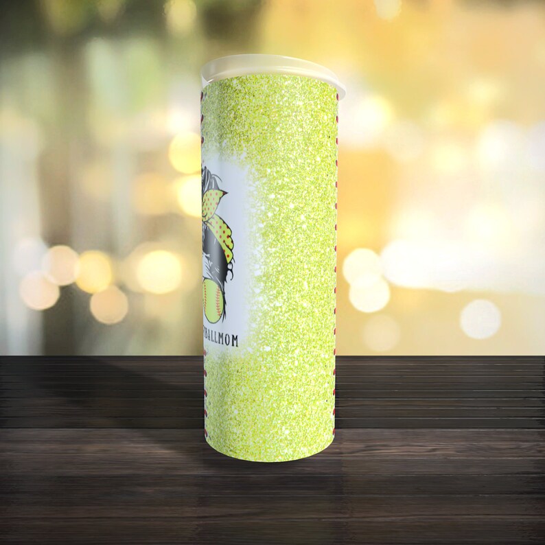May include: A green glitter tumbler with a softball player graphic and the text "Softball Mom".
