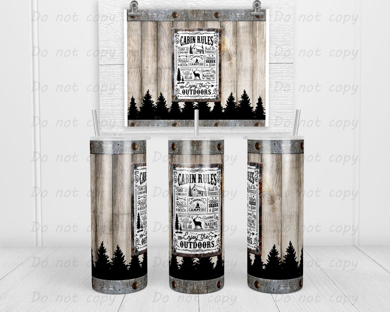 May include: A tumbler with a rustic wood grain design and metal accents. The tumbler features a label with the text "CABIN RULES" and outdoor-themed illustrations. A matching print is displayed in the background. The tumbler is approximately 20 cm tall.