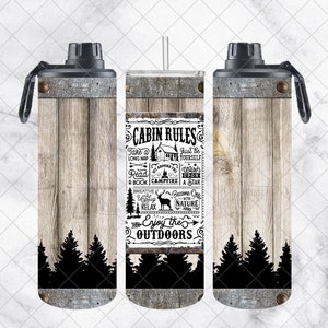 May include: A stainless steel water bottle with a rustic wood grain design. The bottle features the text "Cabin Rules" with outdoor-themed illustrations. The design includes a black silhouette of pine trees at the bottom.