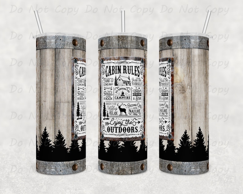 May include: Three insulated tumblers with a wood grain effect. Each has a black and white graphic with the text "Cabin Rules" and illustrations of trees, a cabin, and a deer. Includes a clear lid and straw. The tumblers are cylindrical.