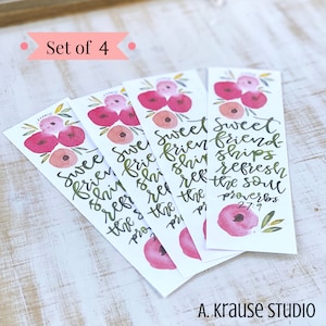 May include: Set of four watercolor bookmarks. Each bookmark features a floral design with pink and peach flowers and green leaves. The text reads "Sweet friendships refresh the soul" from Proverbs 27:9. The artist's name, A. Krause Studio, is at the bottom.