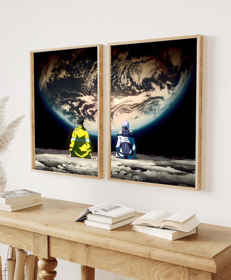May include: Two framed art prints depict anime-style figures seated on a lunar surface, gazing at a large, detailed planet. The prints have wooden frames and are displayed on a white wall. The artwork features a dark color palette with vibrant accents.
