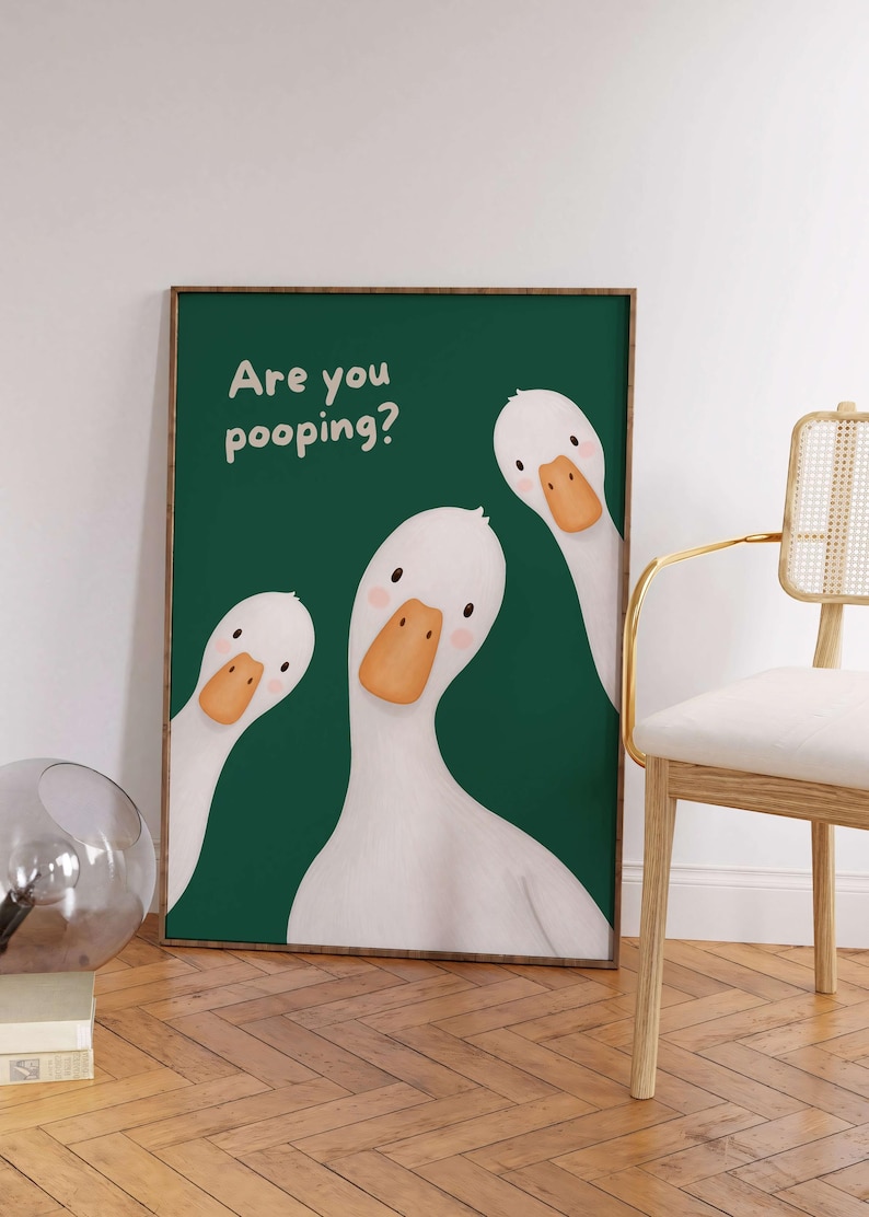 May include: A rectangular wall art print featuring three white geese with orange beaks on a dark green background. The text "Are you pooping?" is printed in a light cream color in the upper left corner of the framed artwork.