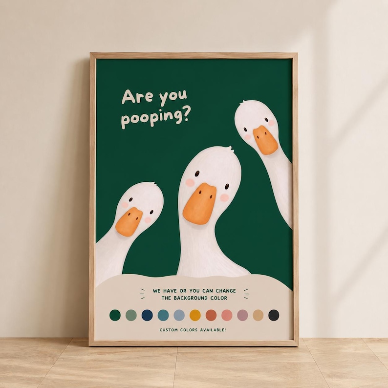 May include: A framed wall art print featuring three white geese with orange beaks against a dark green background. The text reads "Are you pooping?" at the top. Below the geese, a color palette shows circles of various colors for customization.