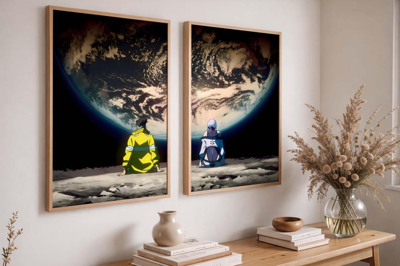 May include: Two framed art prints featuring anime-style characters gazing at a planet. One character wears a yellow jacket, the other a white and blue outfit. The background shows a dark blue space and a large planet with a cloudy atmosphere.